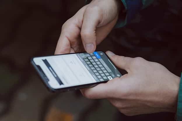 selective focus photography of person using smartphone selective focus photography of person using smartphone